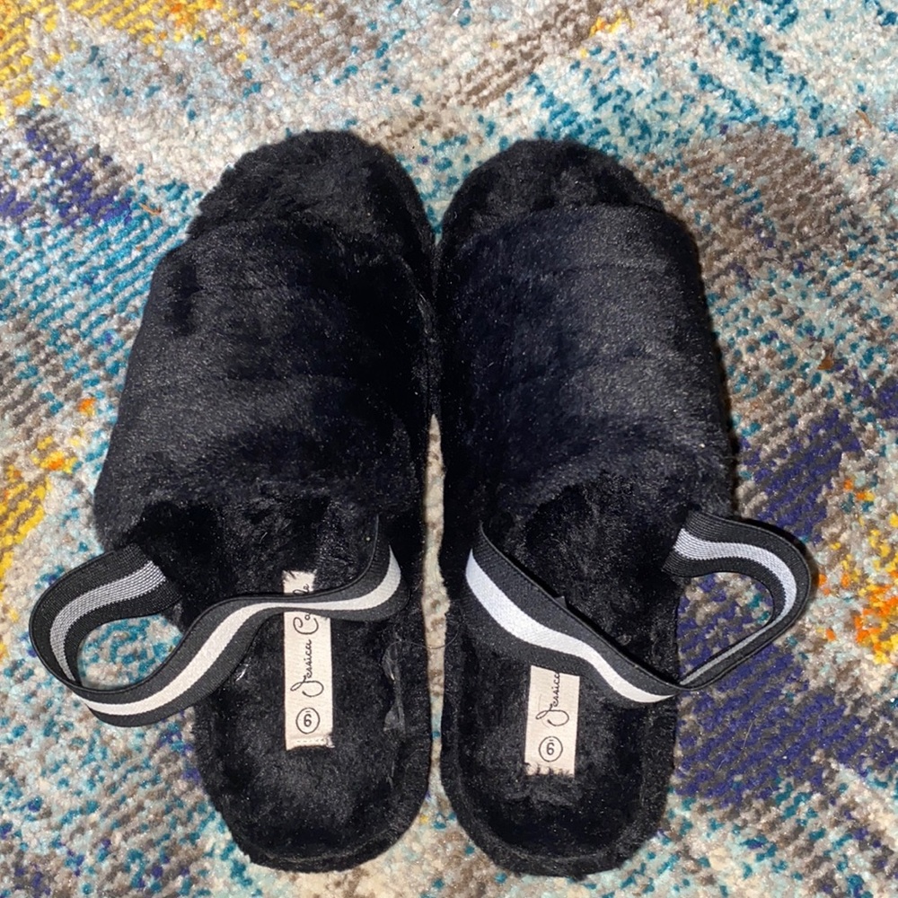 These are a pair of black faux fur sandals that are pre owned but barely worn.
